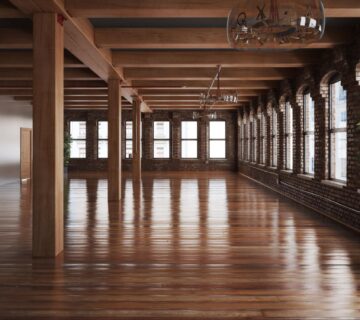 A building hall featuring wooden accents and a polished hardwood floor.
