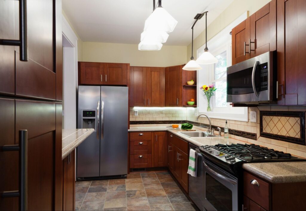 Elegant kitchen with built in appliances and rich brown wood cabinets for a warm, modern look 