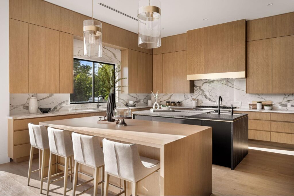 Modern kitchen featuring wooden cabinets and white marble countertops for a clean, natural look 