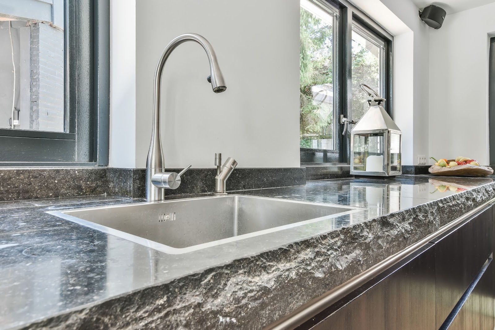 Modern kitchen design featuring a sleek black marble countertop.