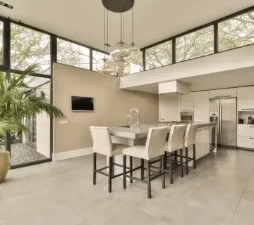 A large shot of a kitchen with off white porcelain flooring 