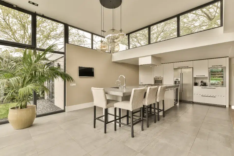 A large shot of a kitchen with off-white porcelain flooring.