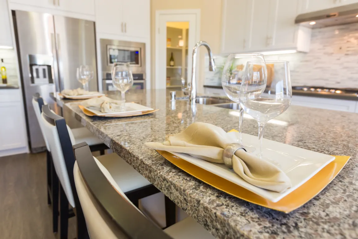 Top-down shot of a quartz countertop with jars and fruits on its surface.