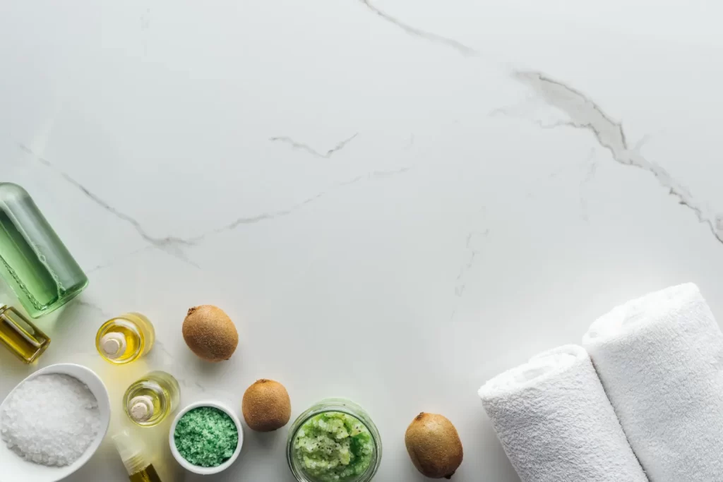 Top-down shot of a quartz countertop with jars and fruits on its surface.