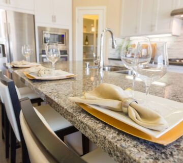 A close up view of a kitchen with granite countertops.