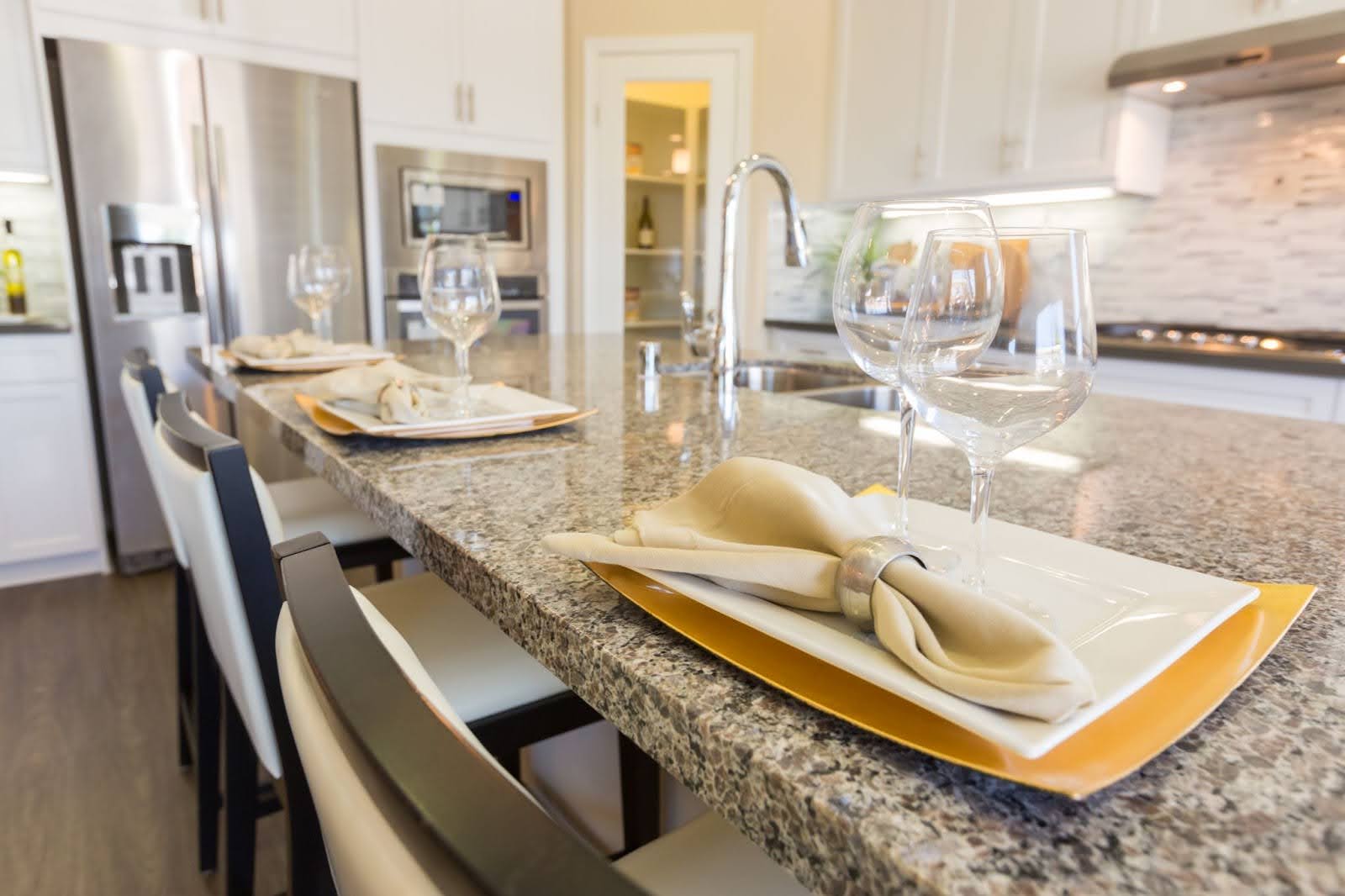 A close up view of a kitchen with granite countertops.