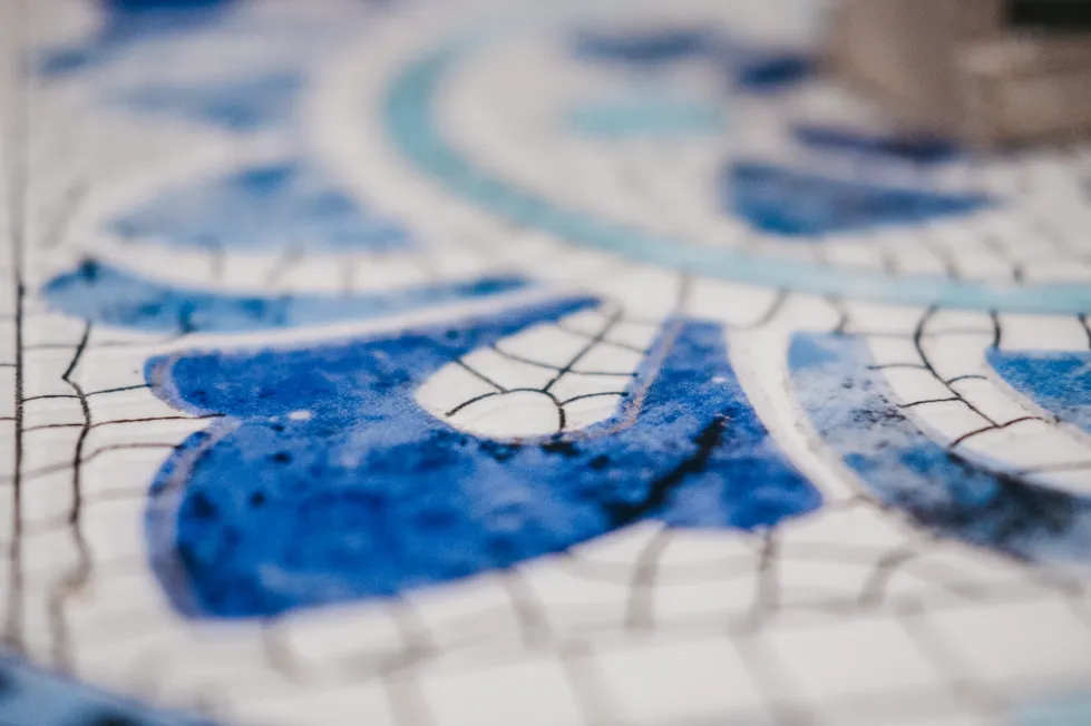 A close up of a blue and white mosaic design.