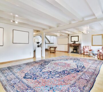 A large designer carpet sits in a living room 